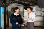 Car Mechanic With Angry Female Customer Stock Photo