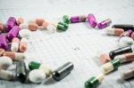 Heap Of Medicine Pills On Cardiogram Grid Paper. Selective Focus Stock Photo