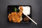 Japanese Food Tonkatsu Rice And Vegetable Take Away On Table Background Stock Photo