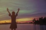 Silhouette Of Woman Praying Over Beautiful Sky Background Stock Photo