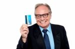 Old Man Wearing Eyeglasses Holding Up A Cash Card Stock Photo