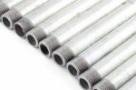 Line Of Iron Water Pipe With Strand On White Floor Stock Photo