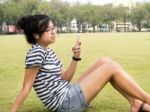 A Young Girl With Headphones Outdoors. Listening Music Stock Photo