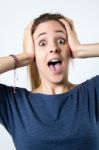 Young Surprised Woman Holding Her Face Stock Photo