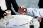 Business Handshake Over A Coffee Stock Photo