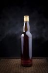 Whiskey Bottle On Wood Background Stock Photo