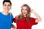 Adorable Young Couple Enjoying Music Stock Photo