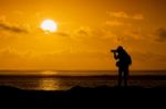 Silhouette Of Photographer With Camera At Sunset Stock Photo