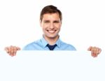 Smiling Businessman Holding Board Stock Photo