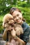 Asian Women Hug With Poodle Dog  I Stock Photo