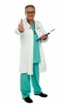 Smiling Aged Doctor With Thumb Up Stock Photo