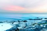 The View Of The Sand Beach And Sea Wave With Rock And Reef On Morning With Sunrise Stock Photo