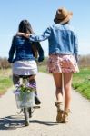 Two Beautiful Young Women With A Vintage Bike In The Field Stock Photo