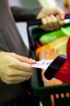 Shopper Taking Ticket For Service Stock Photo