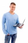 Smiling Young Man With Laptop Looking At Camera Stock Photo