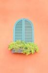 Old Arched Green Window On Orange Wall Stock Photo