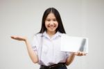 Portrait Of Thai High School Student Uniform Beautiful Girl Using Her Tablet Stock Photo