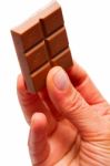 Hand Holding Chocolate Stock Photo