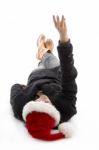 Lying Female Wearing Christmas Hat And Counting Fingers Stock Photo