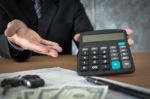 Car Salesman Holding A Key And Calculating A Price At The Dealer Stock Photo