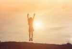 Silhouette Of Woman Jumping Against Beautiful Sky Background Stock Photo