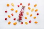 Red And Yellow Cherry Tomatoes On A White Background, Top View Stock Photo