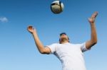 Football Player Striking The Ball At The Stadium Stock Photo