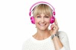 Portrait Of A Cheerful Woman With Headphones On Stock Photo