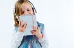 Beautiful Child Listening To Music With Digital Tablet Stock Photo