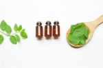 Mint Essential Oil In A Glass Bottle With Leaves Stock Photo