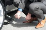 Man Repairing His Car Roadside Stock Photo