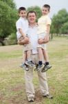 Father Carrying His Two Son In His Hands Stock Photo