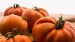 Freshly Picked Tomatoes, Place On Wooden Chopping Board And Table Stock Photo