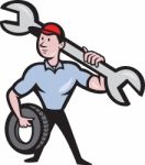 Mechanic With Tire Socket Wrench And Tire Stock Photo