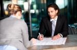 Colleagues Discussing Business Plan Stock Photo