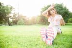 Asian Woman Are Tired Sitting On The Lawn Stock Photo