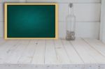 Green Chalkboard And Bottle Seashell In White Room Stock Photo