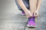 Woman Tying Her Shoes Preparing For A Jog Stock Photo