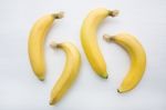 Banana On White Wooden Background Stock Photo