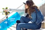 Young Beautiful Girls With Denim Suit In A Urban Background Stock Photo