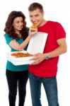 Smiling Couple Eating Pizza Stock Photo