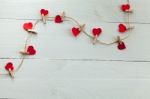 Small Hearts Subjects With Clothespins On White Background Stock Photo