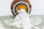 White Pills And Money On White Background Stock Photo