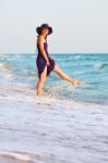 Happy Girl Playing With Water In The Sea Stock Photo