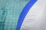 Rain Water Drop On Blue And Grey Umbrella At Poolside Stock Photo