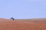 Tractor Plowing On Field Stock Photo