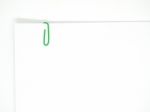 Green Paperclip Attached On White Paper Isolated Stock Photo