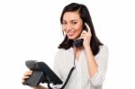 Charming Businesswoman Attending Client's Call Stock Photo