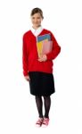 Standing Schoolgirl Holding Books Stock Photo