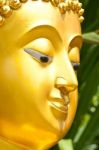 Golden Buddhist Statue Face Stock Photo